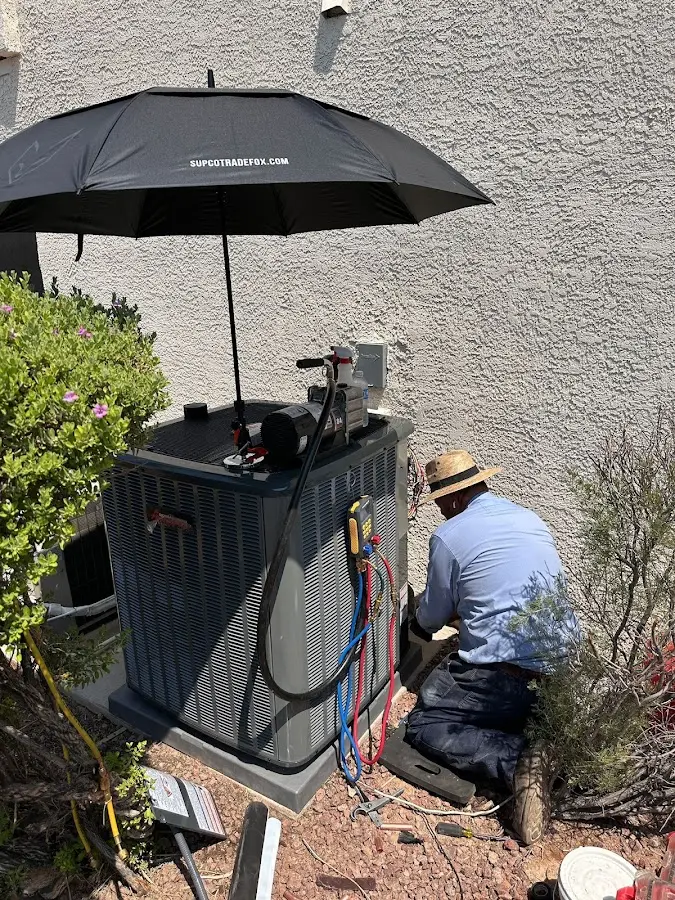 HVAC technician performing outdoor AC maintenance in Verona